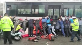 Dozens of pedestrians lift bus up to rescue girl trapped underneath in southern China