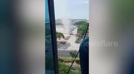 Dust devil whips through car park in the Philippines