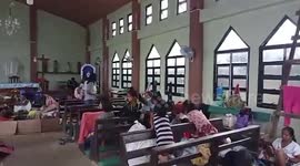 Residents shelter in church during Typhoon Surigae in the Philippines