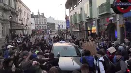 Chelsea fans sing 'Football's Coming Home' while spraying beer and climbing on top of a car