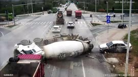 Concrete mixer truck flips over and crashes into car on Chinese road