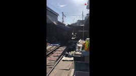 'Stunning Timelapse of a Train Passing Through a Busy Thai Market'