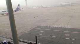 Dust storm engulfs planes at Delhi airport in India