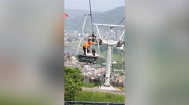 Tourist argues with workers as she is left stranded on cable car due to power cut in southern China
