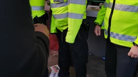 Police attempt to stomp out flare at Kroneke Out Protest at Emirates Stadium