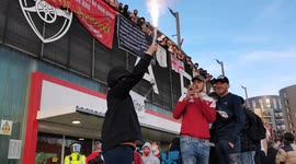 Child lets off flare at Kroneke Out protest at Emirates Stadium