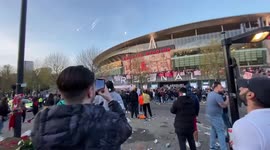 Fireworks outside The Emirates Stadium as fans protest club owner