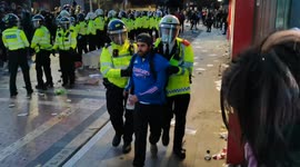 Protestor is arrested and dragged away by riot police at Kroenke Out protest