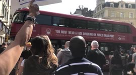 Anti lockdown protesters sticker a stationary bus in London, during a unite for freedom protest