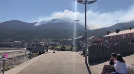 Helicopter flying over Slieve Donard as fire fighters try to put out gorse fire