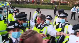 Cop with bloodied face tries to calm crowd in London's Hyde Park as anti-lockdown protesters hurl projectiles at police