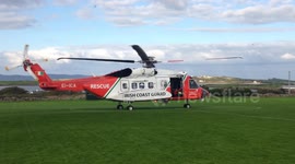 Irish Coast Guard Helicopter Rescue 115 taking off from a local soccer pitch in the sea side village of Fenit Co Keyrr