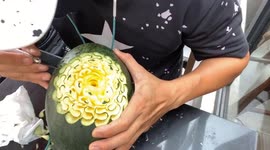 Vietnamese man carves beautiful roses flowers out of yellow watermelon