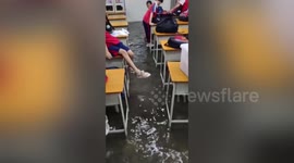 Streets and classrooms submerged after heavy rainstorm strikes southern China
