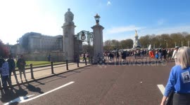 Anti-lockdown protesters stride past Buckingham Palace