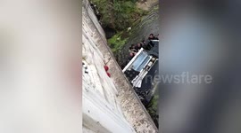Dozens of pedestrians flip over car in river to allow passengers to escape  in China