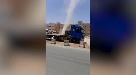 Dust devil tornado passes by front of homes in the Saudi Arabia
