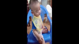 Mother films as her 1-year-old son nods off while watching TV in chair
