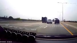 Terrifying moment piece of metal kicks up from road and smashes car window