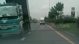 Truck driver unwittingly lifts backloader along the road