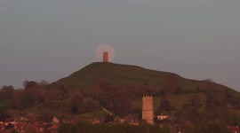 Supermoon rising behind Glastonbury Tor: timelapse footage