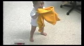 Baby tries to wear a jacket
