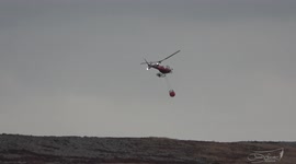 Footage of a fire service helicopter assisting to help put wildfire out on Moorland