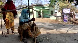 Indian women armed with sticks barricade village to stop spread of COVID-19