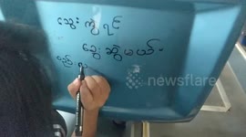 Protesters against Myanmar’s military coup return to the streets - by taking over a bus and writing graffiti on seats