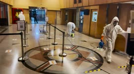 Cleaners in hazmat suits disinfect office block in Bangkok amid Covid-19 surge