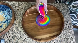 US creator makes vibrant artwork by pouring neon paint into trays