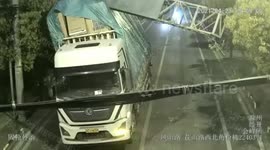 Overloaded truck knocks down huge billboard in eastern China