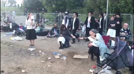 Israel stampede: Pilgrims wait for buses at foot of Mount Meron to take them home
