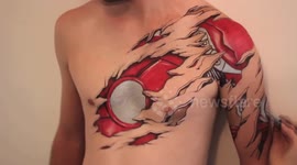 Artist draws Iron Man suit onto body