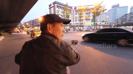Risky ride on the back of a moto-taxi in Chinese rush hour