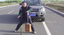 Man pulls car with can held by suction