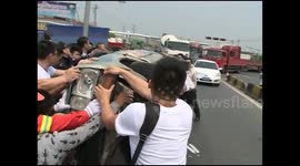Passers-by pull driver from under crashed car