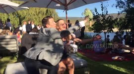 Man swipes bridal bouquet away from his girlfriend