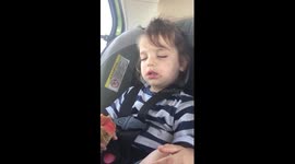 Toddler falls asleep while eating an ice cream