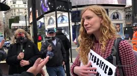 Extinction rebellion protester gets peacefully removed by police after she blocks off a road in Piccadilly Circus