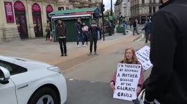 Extinction Rebellion protester blocks off a road in Piccadilly Circus