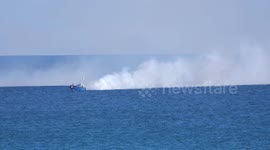 House of Dragon filming at St Michaels Mount island in Cornwall UK, Film techs produce smoke for action boat scene. GOT prequel series