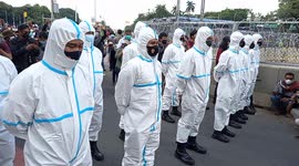Indonesian police wear white hooded coveralls during workers' protests