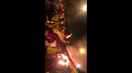 Colombians run around fire and chant 'Resistance