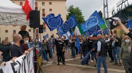 flags in a right-wing political demonstration and national anthem