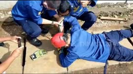 Fire Fighters Evacuate Citizens' Mobile Phones Entering a Water Channel Hole in Cipayung, East Jakarta