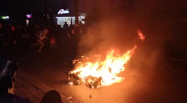Skater Attempts Jump Over Burning Dustbin During Berlin's May Day but is Knocked to the Ground by Police Instead