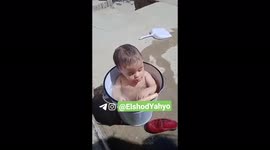 baby water.  baby in a bowl of water baby water.  The boy is bathing in a bowl of water.  youth, pleasure.
