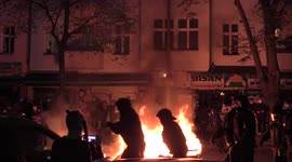 Police Running Past Dustbin Fire and Demonstrators Removing Bike and E-Scooter from Burning Blockade During May Day in Berlin