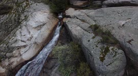 Waterfall with a lot of water and river and a lot of trees in a sunny day